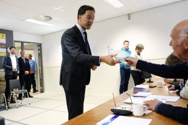 Netherlands Prime Minister Mark Rutte at a polling station in Th clipart