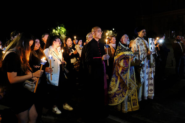 Orthodox Christian worshipers take part in the Epitaph Litany during Holy Friday afternoon in church of Saint Theodore in Rome, Italy on April 26th, 2019.