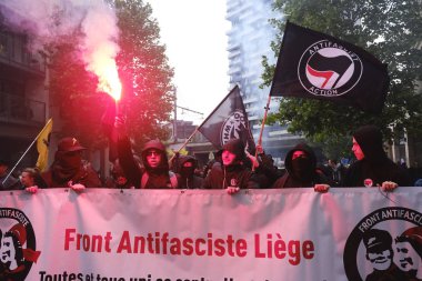 Brussels, Belgium. 28th May 2019. Protesters holding up signs  and shout sloguns during a protest against the rise of far right and fascism. clipart