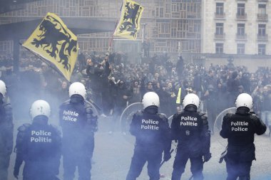 Far-right supporters clash with riot police during a protest against Marrakesh Migration Pact in Brussels, Belgium on Dec. 16, 2018. clipart