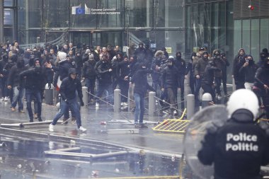 Far-right supporters clash with riot police during a protest against Marrakesh Migration Pact in Brussels, Belgium on Dec. 16, 2018. clipart