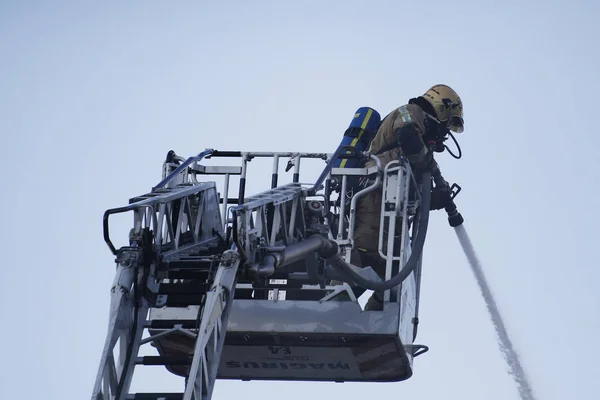 Pompierii încearcă să stingă un incendiu care a izbucnit într-o clădire — Fotografie, imagine de stoc