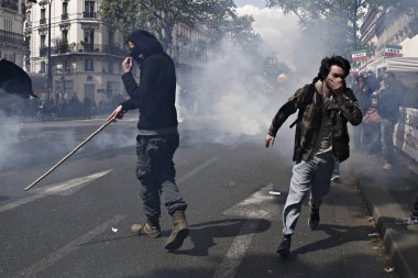 Demonstrators clashed with riot police during a demonstration of the unions members and the 'Gilets Jaunes'  movement marking Labor Day in Paris, France on May 1st, 2017 clipart