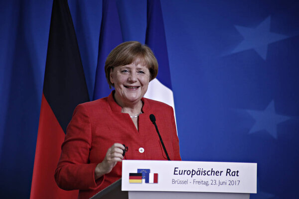 German Chancellor Angela Merkel, left, and French President Emmanuel Macron address the media at an EU summit in Brussels,Belgium on June 23, 2017. 