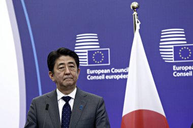 Japan's Prime minister Shinzo Abe is welcomed by EU Council President Donald Tusk and EU Commission President Jean-Claude Juncker at the EU Japan leader's summit meeting in Brussels on 3 May 2016. clipart