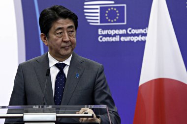 Japan's Prime minister Shinzo Abe is welcomed by EU Council President Donald Tusk and EU Commission President Jean-Claude Juncker at the EU Japan leader's summit meeting in Brussels on 3 May 2016. clipart