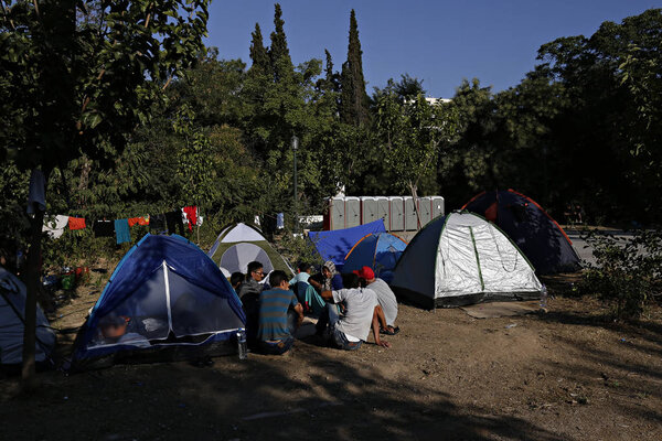 Refugees and migrants in a makeshift camp at Pedion tou Areos park where some 1500 migrants and refugees live in a makeshift camps in Athens, Greece on Aug. 3, 2015