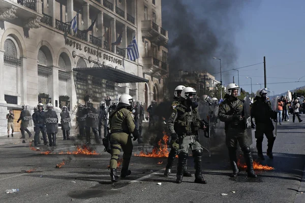 Atina, Yunanistan, 2 Decemeber 2015 hükümetin tasarruf politikası karşı 24 saat genel grev sırasında protestocular ile çatışmalar sırasında isyan polisi bir benzin bombası patlar.