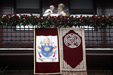 Pope Francis, left, and Ecumenical Patriarch Bartholomew I hold their hands and wave to faithful after a holy liturgy at the Patriarchal Church of St. George in Istanbul, Sunday, Nov. 30, 2014.  clipart