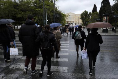 Yayalar, Atina 'da yağış sırasında şemsiyeler ile yağmur kendilerini korumak, Yunanistan 4 Nisan, 2019