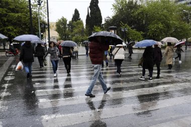 Yayalar, Atina 'da yağış sırasında şemsiyeler ile yağmurdan kendilerini koruyacak, Nisan 'da Yunanistan 8, 2019
