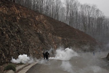 Polis Kasım'da Yunanistan'ın Chalkidiki yarımadasının Skouries bölgesinde altın madenciliği karşı bir protesto sırasında göstericilere karşı göz yaşartıcı gaz kullanır 23, 2014