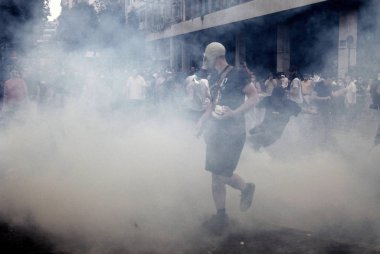 Polis ve göstericiler 28 Haziran 2011 tarihinde Atina'da hükümetin politikası ve kemer sıkma kesintilerine karşı 48 saatlik bir genel grev sırasında Yunan parlamentosu önünde çatışma