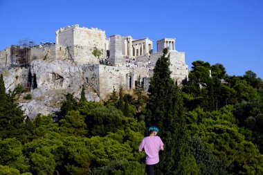 Turistler Atina'daki anıttan fotoğraf çekerken Akropolis tepesini ziyaret ettiler, Yunanistan 9 Ağustos 2019