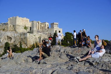 Turistler Atina'daki anıttan fotoğraf çekerken Akropolis tepesini ziyaret ettiler, Yunanistan 9 Ağustos 2019