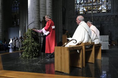Priests ateend in a mass celebrating Saint-Arnould, patron saint of brewers, at the Cathedral of St. Michael  in Brussels, Belgium on Sep. 6, 2019. clipart