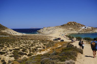 18 Ağustos 2019 tarihinde Yunanistan'ın Serifos Adası'ndaki Agios Sostis sahilinde güneşte yıkanan, yüzen ve oyun oynayan insanlar
