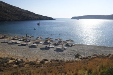 14 Ağustos 2019 tarihinde Yunanistan'ın Serifos Adası'ndaki Vagia sahilinde güneşte yıkanan ve yüzen insanlar