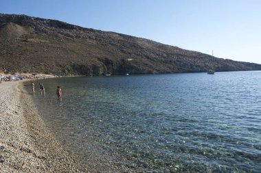 14 Ağustos 2019 tarihinde Yunanistan'ın Serifos Adası'ndaki Vagia sahilinde denizde yıkanan ve oyun oynayan insanlar.