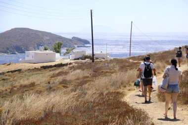 People walk in rocky path  in Greek Island of Serifos on Aug. 19, 2019. clipart