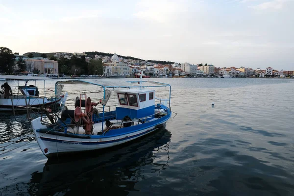 LESBOS ISLAND, GREECE - March 8, 2020. A Fisherman prpeares nets in port. Greek islands are famous for traditional boats used to catch fish — Stock Image Lesbos Island Greece March 2020 Fisherman Prpeares Nets Port Greek Stock Image