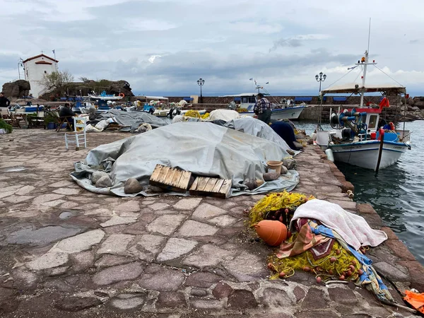 LESBOS ISLAND, GREECE - March 5, 2020. A Fisherman prpeares nets in port. Greek islands are famous for traditional boats used to catch fish — Stock Image Lesbos Island Greece March 2020 Fisherman Prpeares Nets Port Greek Royalty Free Stock Images
