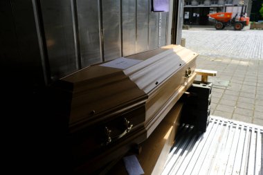 Coffins of victims of COVID-19 in a refrigerated container at the Verrewinkel Cemetery in Brussels, Belgium, on April 29, 2020. clipart