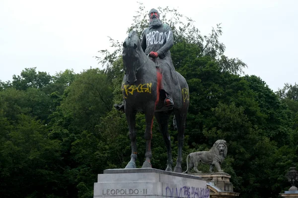 ベルギー王レオポルド2世の像は2020年6月10日にベルギーのブリュッセルで赤いペンキと落書きで塗られています — ストック写真