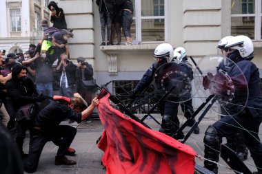 Demonstrators clashed with riot police during an anti-racism protest against racial inequality in the aftermath of the death in Minneapolis police custody of George Floyd in Brussels, Belgium on Jun. 7, 2020. clipart