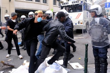 Demonstrators clashed with riot police during an anti-racism protest against racial inequality in the aftermath of the death in Minneapolis police custody of George Floyd in Brussels, Belgium on Jun. 7, 2020. clipart