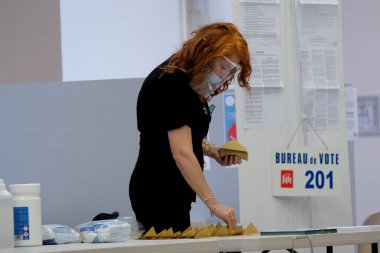 Voters cast their vote in polling station during the second round of the French Municipal elections in Lille, France on June, 28th 2020. clipart