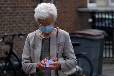 Voters queue outside of a polling station during the second round of the French Municipal elections in Lille, France on June, 28th 2020 clipart