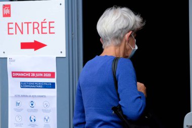 Voters queue outside of a polling station during the second round of the French Municipal elections in Lille, France on June, 28th 2020 clipart
