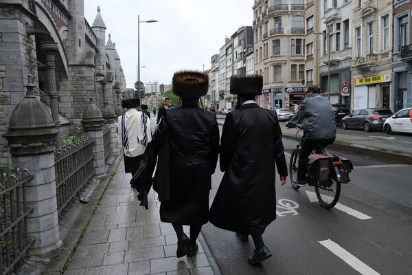 Members of Ultra-Orthodox Jewish community return from the Synagogue after a religion service in Antwerp, Belgium, on Shabbat, July 4, 2020.