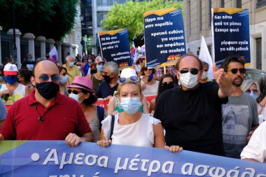 Yüz maskesi takan öğretmenler, 25 Ağustos 2020 'de Yunanistan' ın Atina kentinde yapılacak yeni öğrenim yılı öncesinde okulların güvenli bir şekilde açılması yönünde tedbirler alınmasını talep eden bir protestoya katıldılar..