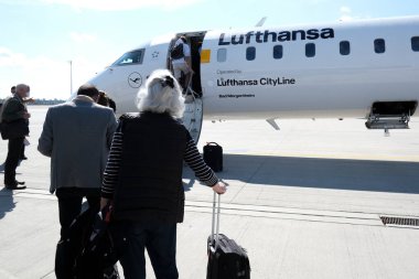 Passengers boarding in a airplane in Munich Airport in Germany on Sept. 3, 2020 clipart