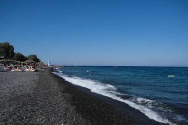 İnsanlar 12 Ağustos 2020 'de Yunanistan' ın Santorini kentindeki Kamari Plajı 'nda dinleniyorlar..