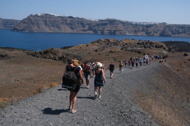 People walk in Nea Kameni Volcanic Park in Greece on August 16, 2020 clipart