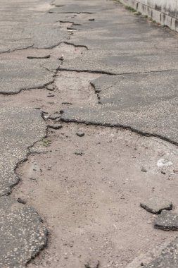 Ailing pothole road requires important infrastructure investment clipart