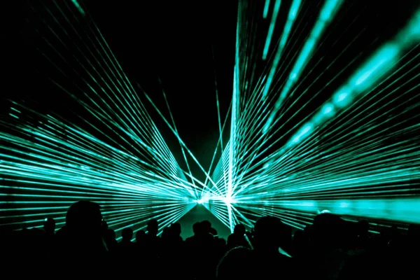 Turquoise laser show nightlife club stage at party people crowd — Stock Photo, Image