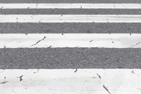 Grey and white pedestrian crossing stripes on city downtown road — Stockfoto
