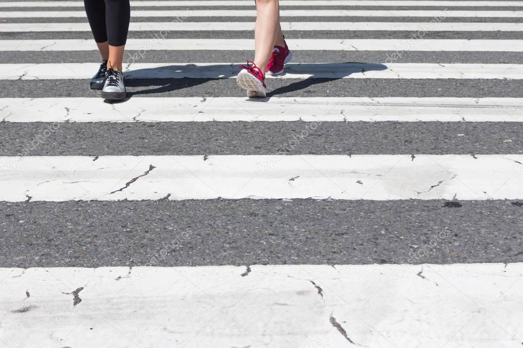 Pedestrian crossing city downtown girls walk in motion on road