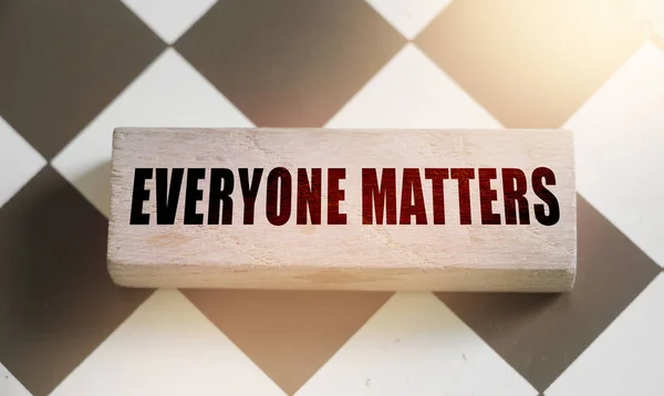 Everyone matters - phrase words from wooden blocks with letters, accepting others individuality everyone matters concept, top view gray background.