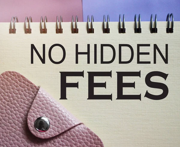 No hidden fees words on copybook page and pink wallet. Financial concept