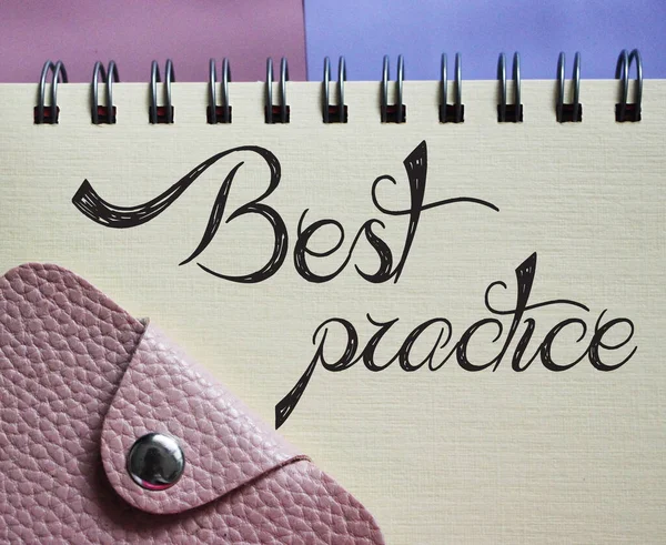 Best Practice text written on a notebook with pink leather wallet. Business concept.