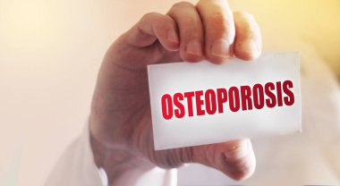 Doktorun kartında Osteoporoz kelimesi var. Romatoloji danışmanlığı, osteoporozdan muzdarip. Sağlık ve tıbbi konsept.