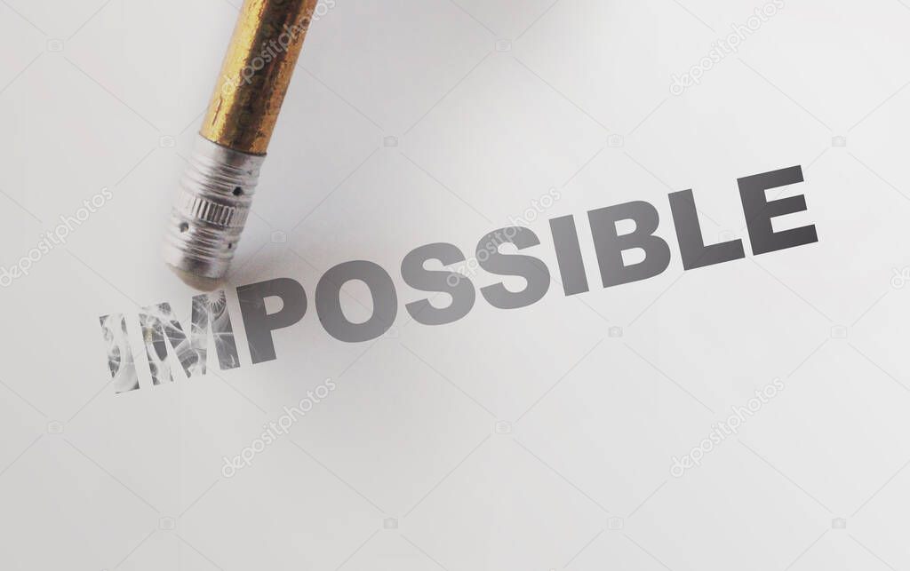 Changing the word impossible to possible with a pencil eraser. Motivation startup concept
