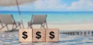 Para biriktirme ve tasarruf kavramı. Elle dolar işareti olan tahta küpler. Kapat..