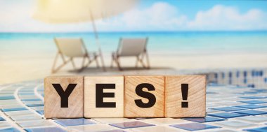 The word Yes written in black letters on wooden blocks in ocean landscape background. Business, motivation and education concept. Vacation and relax concept clipart