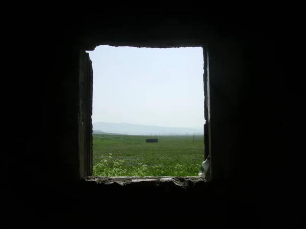 View from the window of a ruined house on the Caucasian mountains